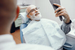 an older man has his six month dental implants checkup